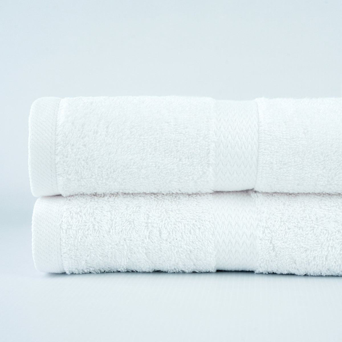 Green Ocean white ring-spun cotton bath towel with dobby border. Manufacturer family photograph.