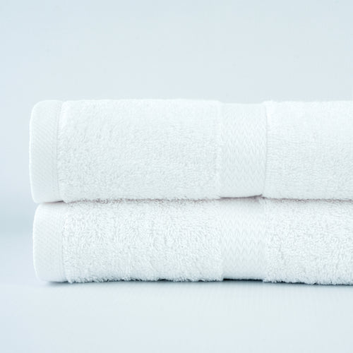 Green Ocean white ring-spun cotton bath towel with dobby border. Manufacturer family photograph.