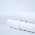 Platinum white ring-spun blended bath towels with double cam border. Manufacturer family detail photograph.
