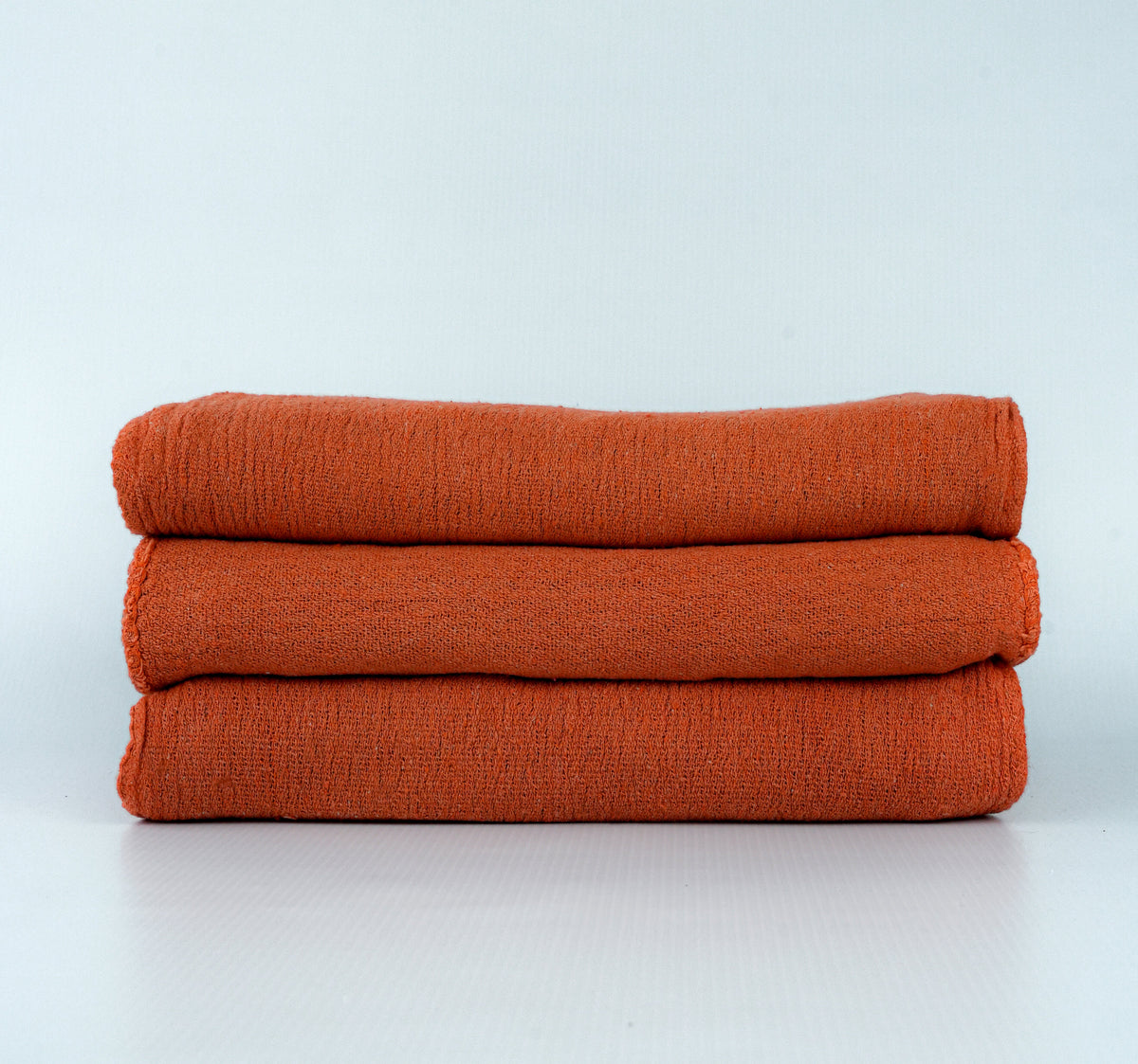 Manufacturer photograph of orange dyed shop towels; shared color-family image.