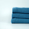 Manufacturer photograph of blue dyed shop towels; shared color-family image.