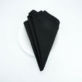 Black 20 x 20 spun polyester napkin, folded presentation. Napkins only; plate is a photo prop.