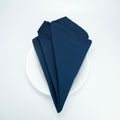 Navy blue 20 x 20 spun polyester napkin, folded presentation. Napkins only; plate is a photo prop.