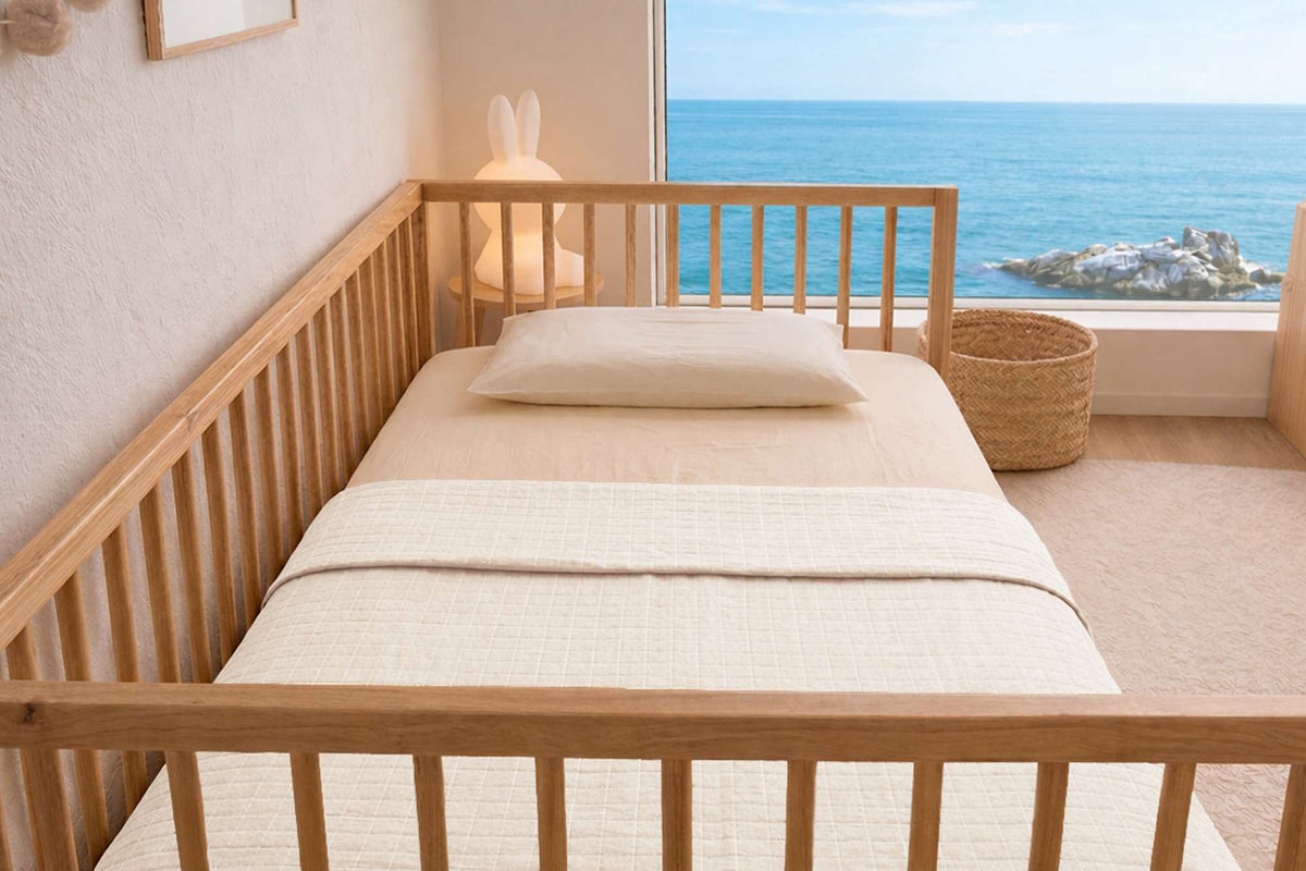 Sleep & Beyond Romi & Rani Organic Cotton Muslin Swaddle. Supplier family gallery explicitly contains this crib/color image. Styling only; only SKU contents included.